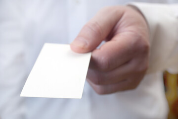 a man holds a layout of a business card