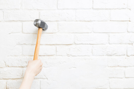 Hammer swung down against the wall
