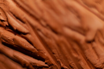 Art concept. Modeled clay. Part of a sculpture modeled with clay with wrinkles and grooves.