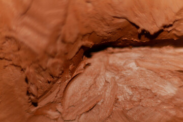 Fototapeta premium Art concept. Modeled clay. Part of a sculpture modeled with clay with wrinkles and grooves.