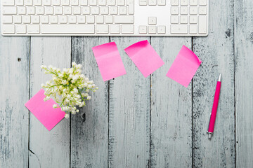 loft style place of work with lily of the valley and pink post its, directly above
