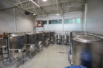 High angle view at fermentation tanks in workshop at industrial brewing factory, copy space