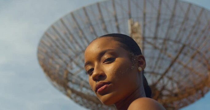 Extreme close up of a model standing in front a military radar tracking station
