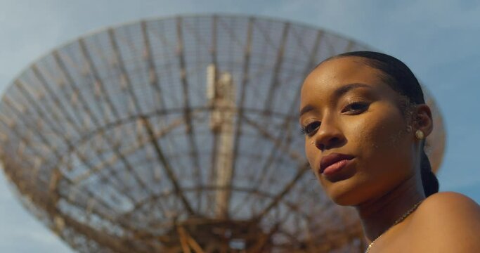 Epic facial close-up of a model with a radar tracking station in the distance on the Caribbean island of Trinidad