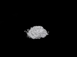 Cocaine drug powder pile on black background