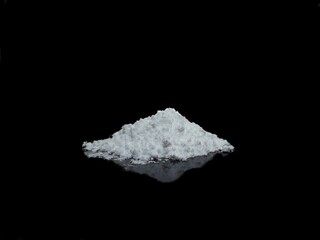 Cocaine drug powder pile on black background