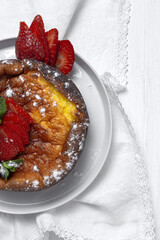 Homemade cheesecake with blueberries, currants, strawberries and mint leaves from above. Flat lay