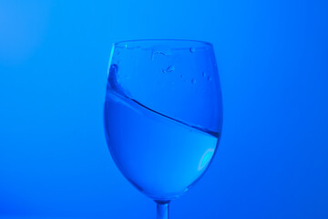 clean water in a glass drop glass in cold tone