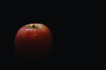 A red apple on black background