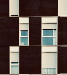 Black brick facade with white windows and shutters