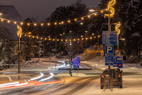 Lighted seasonal decorations above a roundabout at winter evening