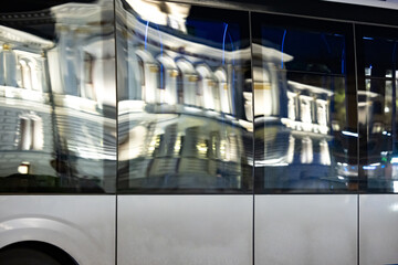 Reflection of a white town hall in bus windows