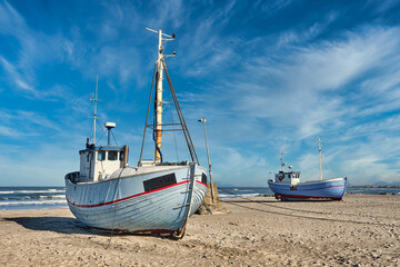 Coastal fishing boats vessels at Vorupoer beach in Western Denmark