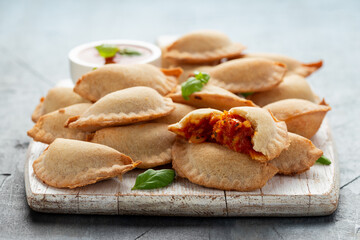 Margarita Margherita pizza parcels pockets filled with tomato, mozzarella cheese and basil served...