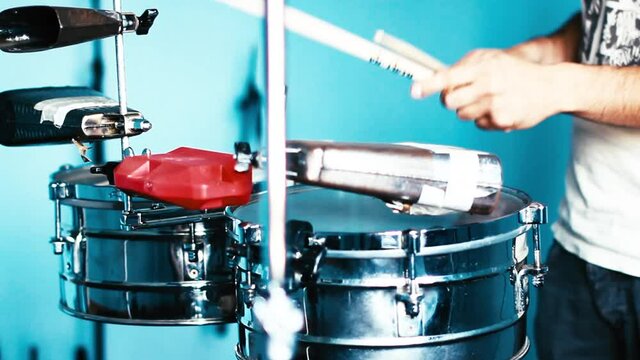 Drummer recording cuban music in a studio.
Close-up of playing cuban Salsa on drums. Cowbell, Jam Block, drumkits and rhythm.