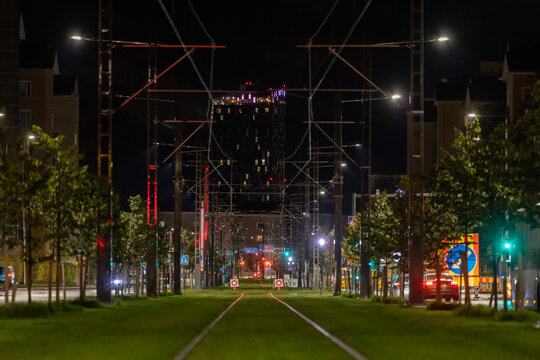 Tram rails on lawn in city center at night