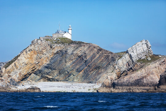 White lighthouse on a steep cliff on French coast