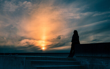 Silhouette of woman at sunset in Senhora da Luz
