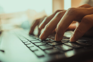 Close focus of man's hands typing. Man working at home office hand on keyboard close up