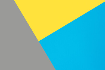 Blue, yellow and gray colored paper. Geometric empty paper background of three tones, copy space