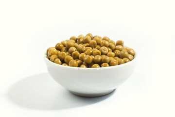 green canned peas in a plate on a white background