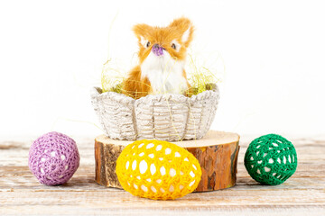 Easter bunny in a basket surrounded by Easter eggs