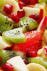 Fruit salad close-up in full screen, as a background.