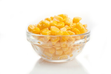 sweet corn in a clear bowl on a white background