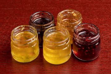 A variety of open small Jars of jelly, marmalade and jam