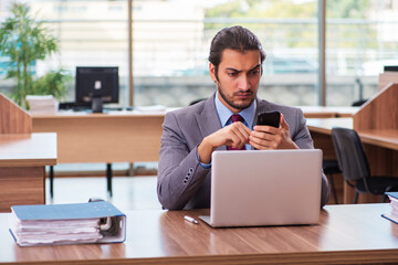 Young male employee working in the office