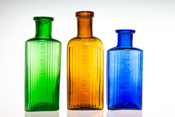 Antique poison medicine bottles on white background