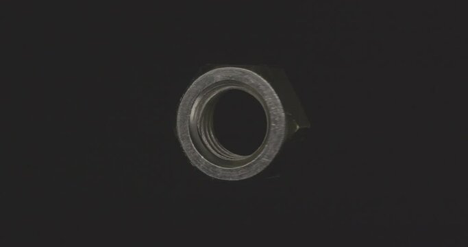 metal nut spinning in the void on a black background