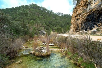 Views of the source of the river Borosa in the Natural Park of the Sierras de Cazorla, Segura y las Villas, Andalusia, Spain. Route on a rainy day - obrazy, fototapety, plakaty