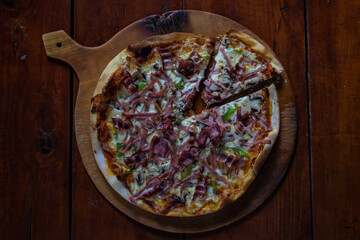 Meat pizza on wooden board