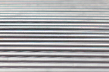 The texture of horizontal parallel lines. Metal sticks close up