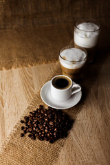 Coffee beans, espresso, cappuccino, latte on the table