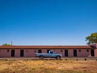 Old pickup truck in front of a motel