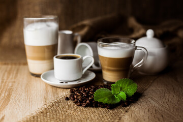 Coffee beans, mint, espresso, cappuccino, latte on the table
