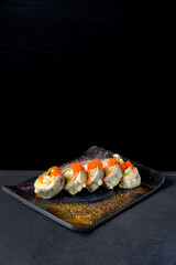 fried sushi  on the dark background