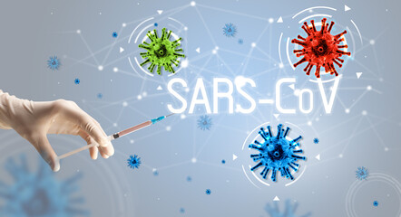Obraz na płótnie Canvas Syringe, medical injection in hand with SARS-CoV inscription, coronavirus vaccine concept