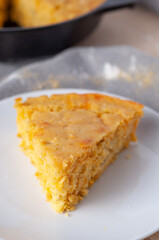 Wedge of cornbread baked in cast iron skillet