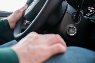 Close up mans hands on the wheel, driving a car. 