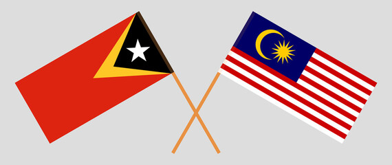 Crossed flags of East Timor and Malaysia. Official colors. Correct proportion