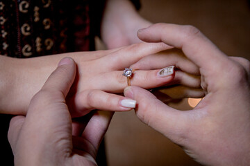 a man puts a ring on his future wife