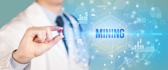 Doctor giving a pill with MINING inscription, new technology solution concept