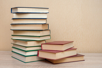 Stack of books on the table on a neutral background