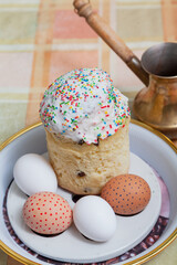 Pasca and eggs on round tray. There is  cezve behind