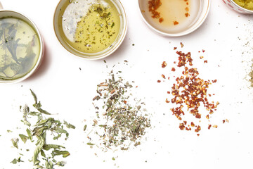 Herbal tea. Tea cups on white and dry herbs top view. Herbs in bulk, zero waste and eco-friendly lifestyle, herbal medicine concept.	