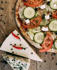 Vegetable pizza with mozzarella, fresh tomatoes and cucumber. Two types of blue cheese