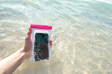 Waterproof case on a smartphone, phone for taking pictures under water. Phone in the waterproof...